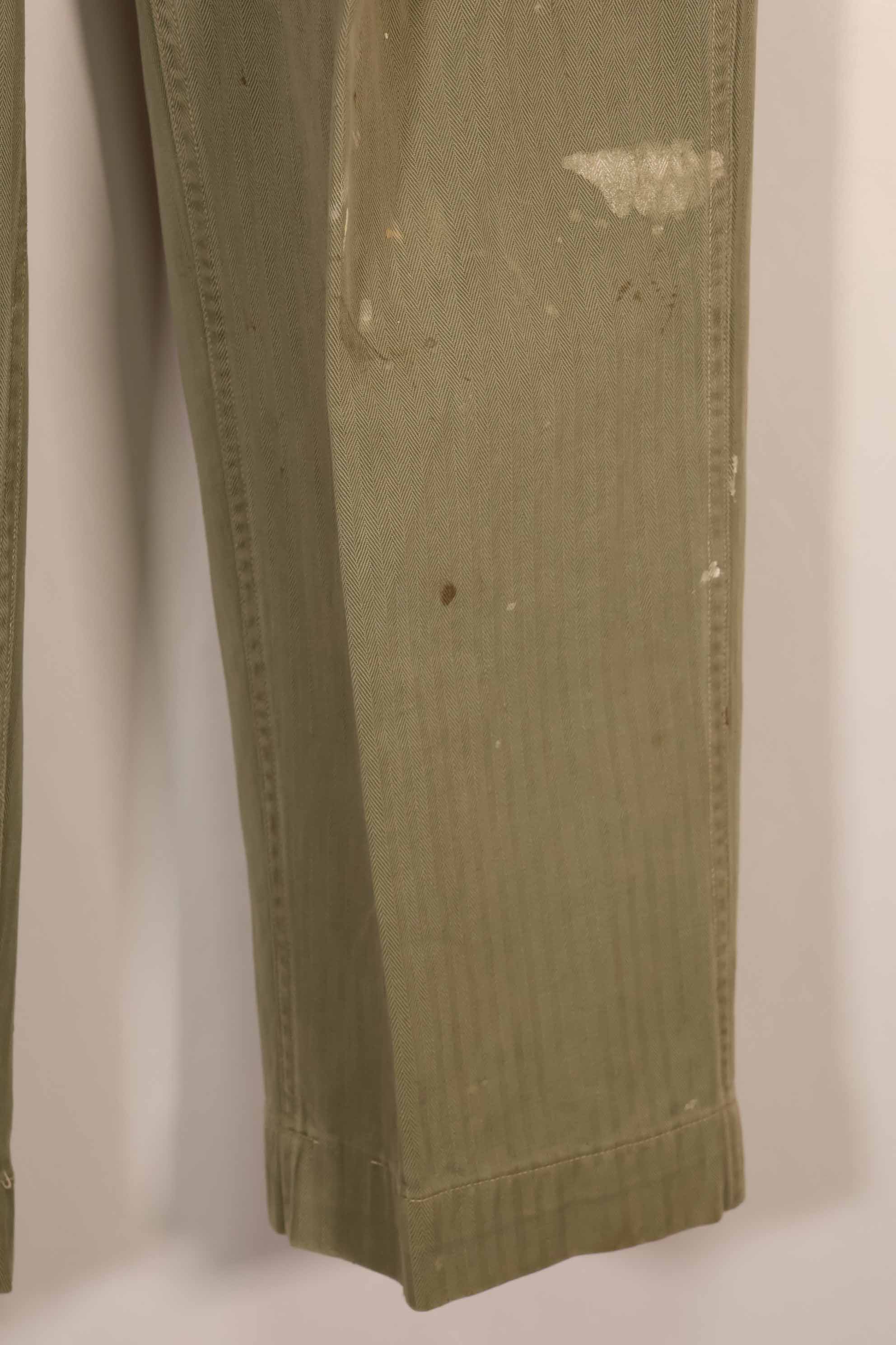 Real 1940s U.S. Marine Corps USMC M42 HBT utility pants, faded, stained.